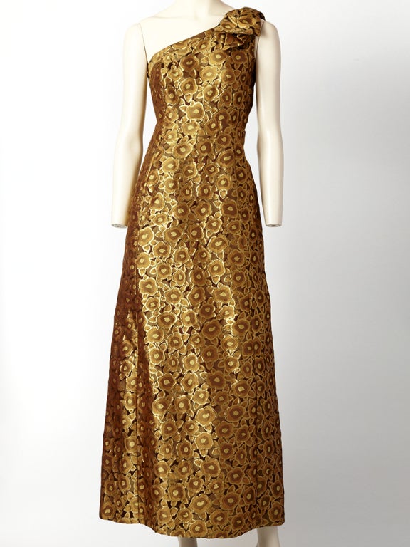Bronze and gold toned, custom made, floral brocade, one shoulder evening dress with a fitted bodice and full skirt. Shoulder has a self bow detail.