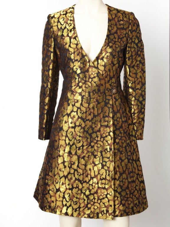 Valentino, copper and gold tone brocade dress in an abstract leopard print. Dress had a deep V neck with a fitted bodice and wrap, side closure with a sculpted A line skirt. Beautiful rich fabric.