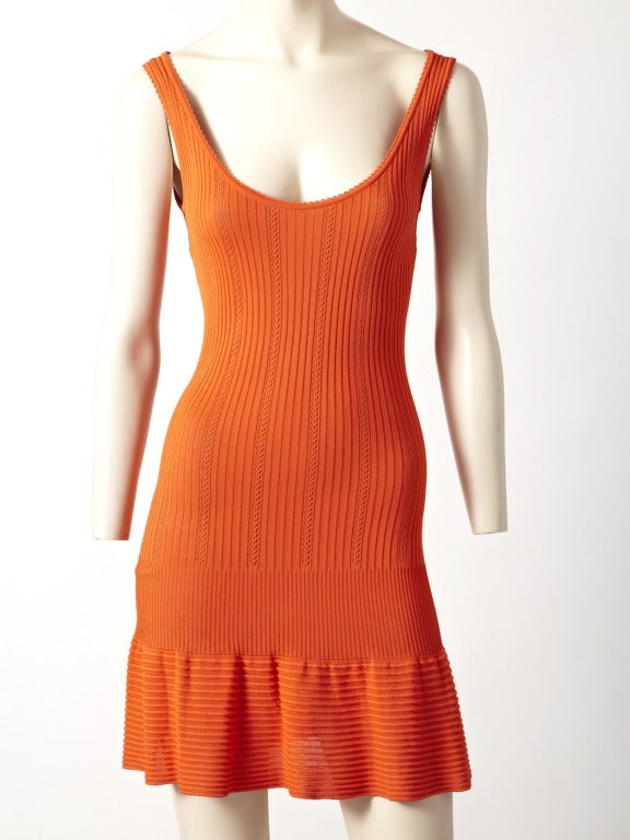 Azzedine Alaia, textured, jersey, viscose knit, tank style, mini dress with a fitted bodice and a flounced hem detail.