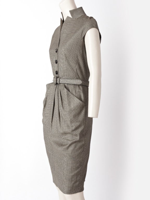 John Galliano, for Dior, beige and black, wool houndstooth, belted day dress with a stand up mandarin collar side pockets and draped detail at the waist and hip.