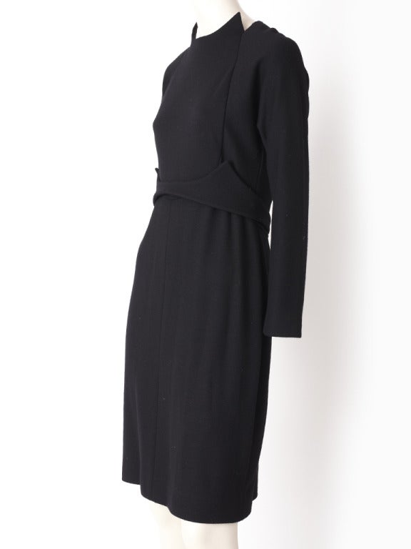Geoffrey Beene, wool jersey, little black fitted day dress with high neckline with cut outs, slightly empire waist with wide soft self belt echoing the lines of the neckline.