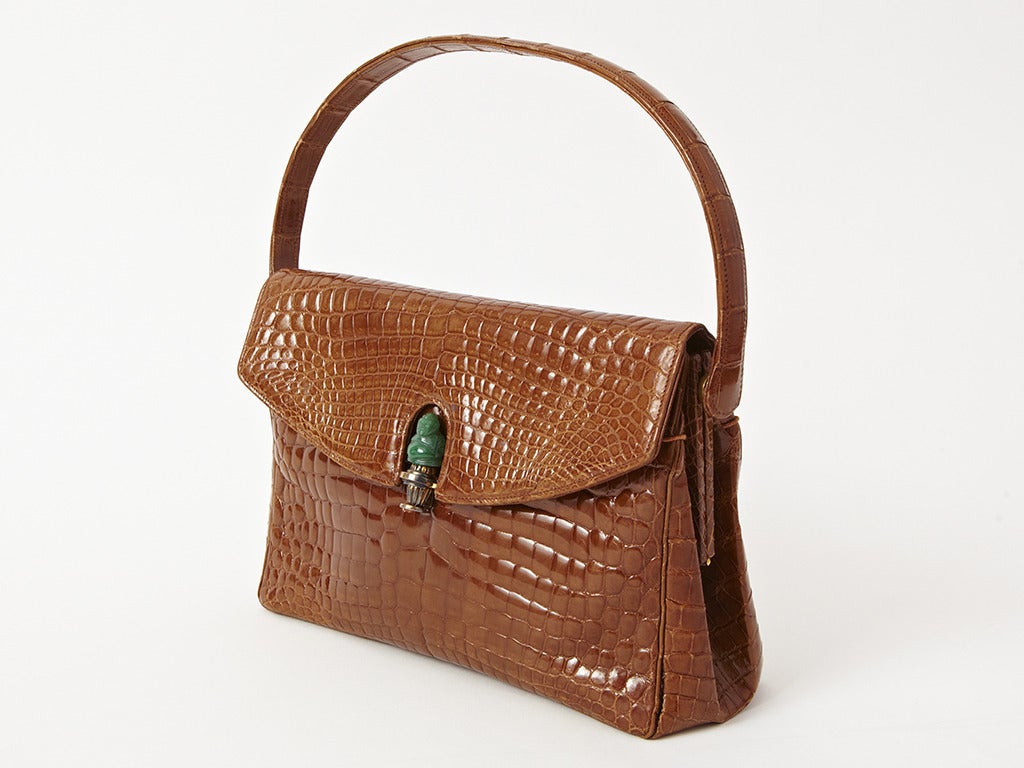 Morabito, paris, glazed, cognac colored, croc handbag with a jade clasp.
Interior is all leather.