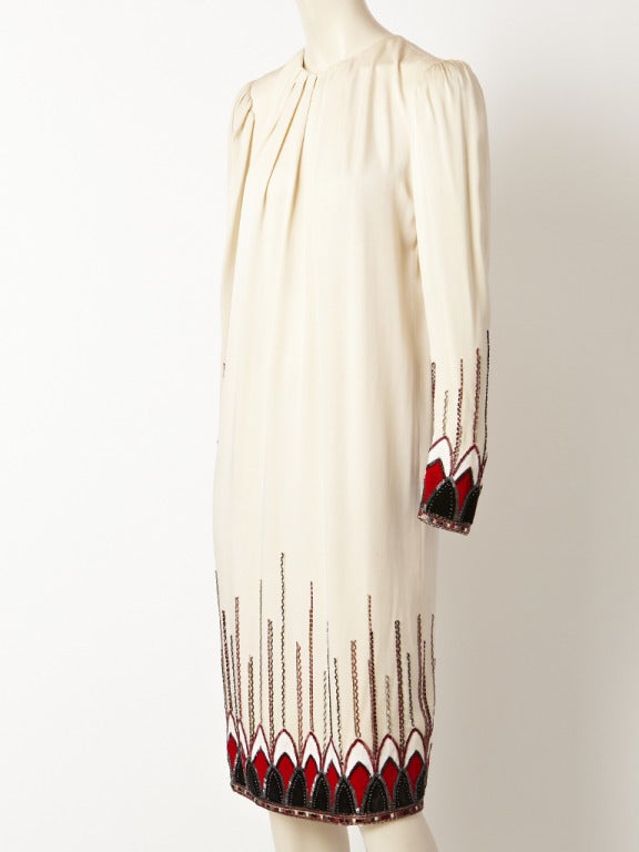 Givenchy, ivory silk charmeuse, cocktail dress with bugle beading. Body of the dress is 1920's chemise style, with gathering at the neckline. The dress has an art deco inspired motif of bugle beading at the hem and cuffs.