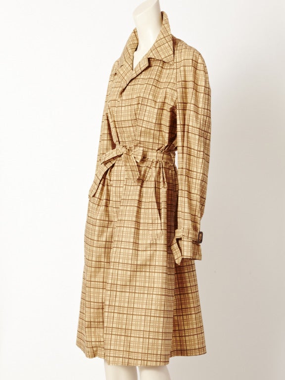 Gucci, beige and brown, plaid belted trench in a treated cotton suitable for the rain.