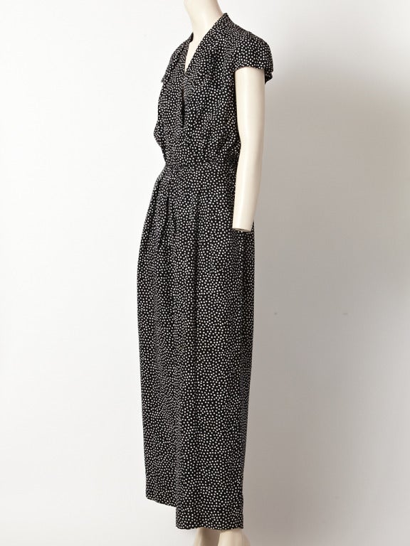 Oscar de la Renta, silk, polka dot jumpsuit with a cap sleeve, wrap-like bodice, and wide leg pant.