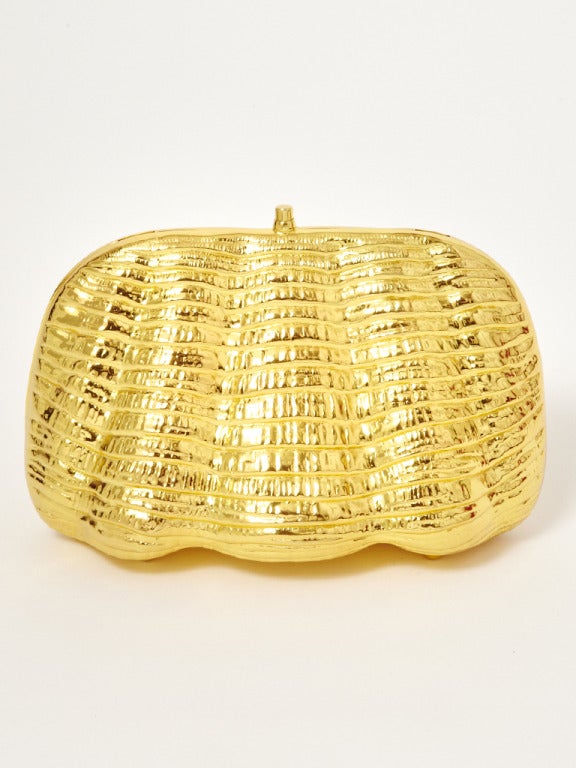 Todo, made in Italy, textured hard, clamshell shape, minaudière evening bag with optional chain. Interior of bag is gold leather.
