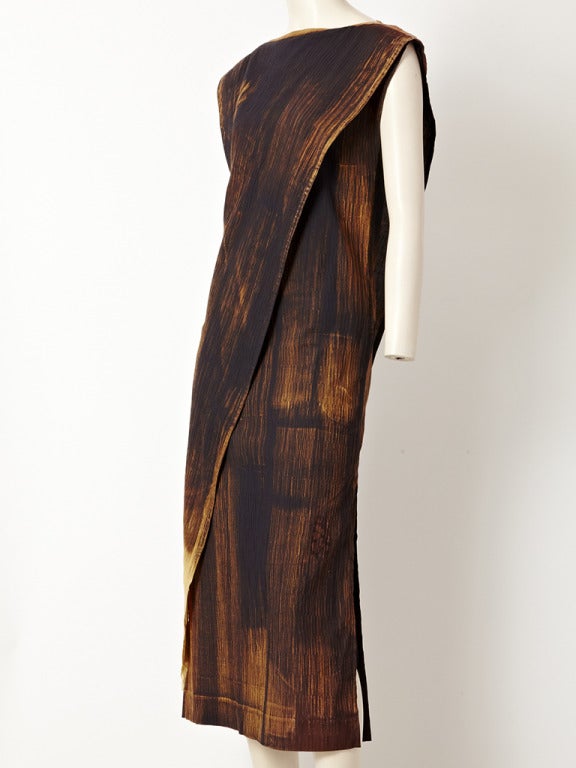 Ronaldus Shamask, painterly, abstract pattern, African inspired sheath dress.
Earth tone, bateau neckline,with cap sleeves and an asymmetric free panel that starts at the neckline and narrows down to a point to the side of the dress.
