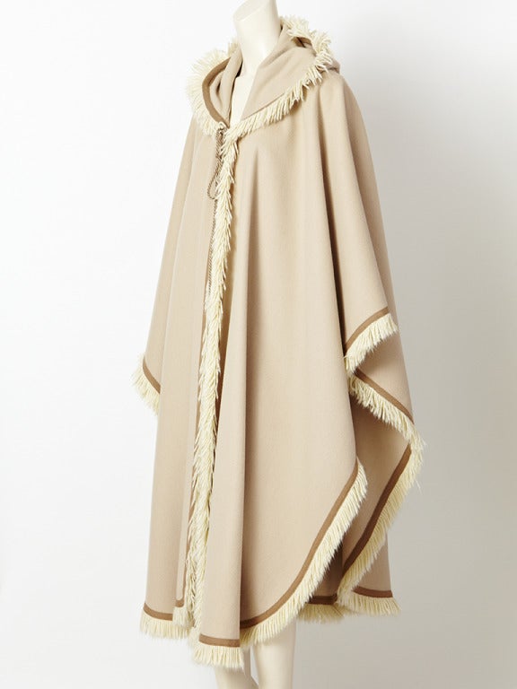 YSL, beige, wool, Moroccan  inspired cape edged in a wool fringe with tassled hood.
