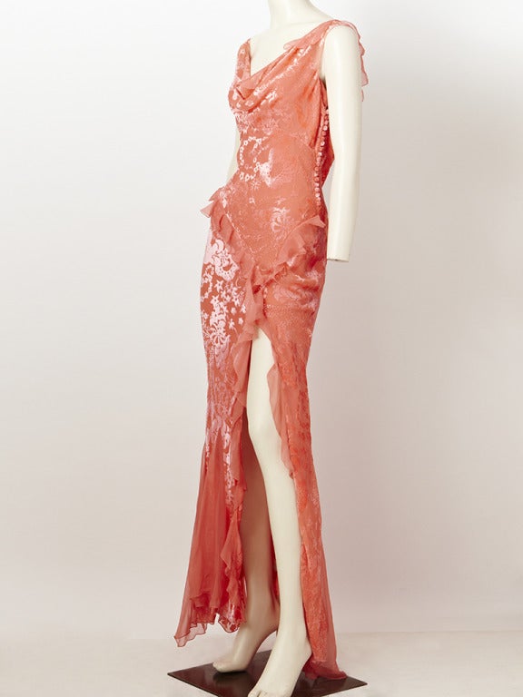 John Galliano for Christian Dior, salmon toned, cut velvet on chiffon, 
bias cut evening gown. Neckline is softly draped. Deep slit on the left side
shows off the leg. Dress is embellished with chiffon ruffles that are placed
along the hip and