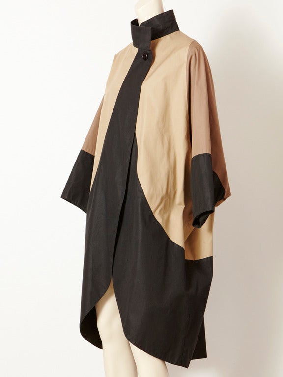 Issey Miyake, cacoon shape raincoat, in a graphic black and khaki.