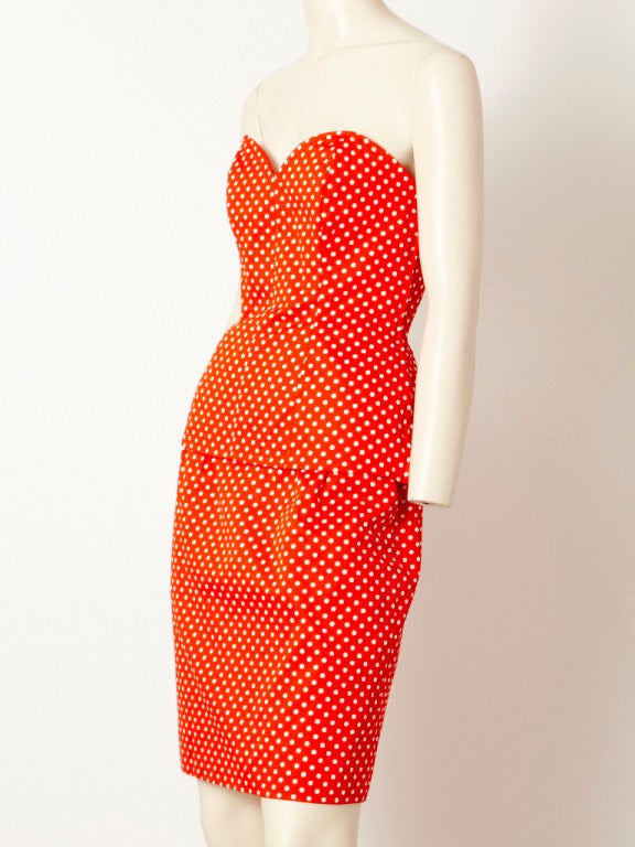 YSL, red and white, polka dot, strapless, fitted bustier that ends at the hip and straight pencil skirt ensemble. Skirt has pockets at the hip and bustier fastens with a side zipper.