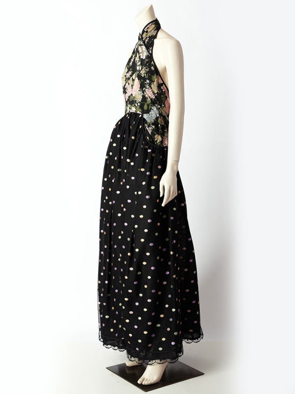 Geoffrey Beene, romantic, halterneck gown. Bodice of dress is made of a floral print crepe de chine silk that has a criss cross halter at the neck and a back that is open to the waist. The floral print silk bodice has panels that extends to the hips
