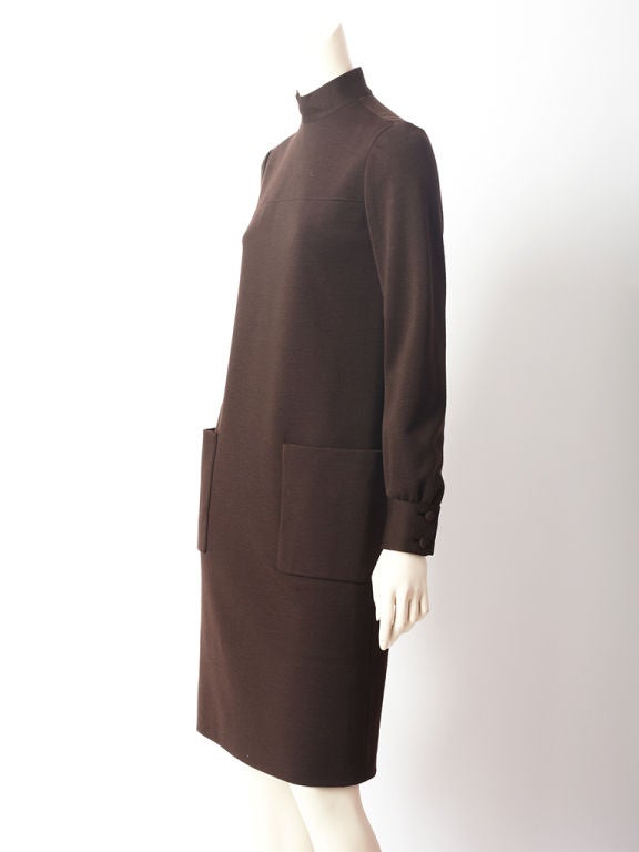 Norman Norell, high neck, wool knit, long sleeve dress with large pocket detail.