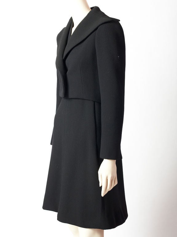 Pauline Trigere wool crepe ensemble consisting of a cropped jacket<br />
and a sleeveless v neck dress that is fitted at the bodice and flares out from the hips.