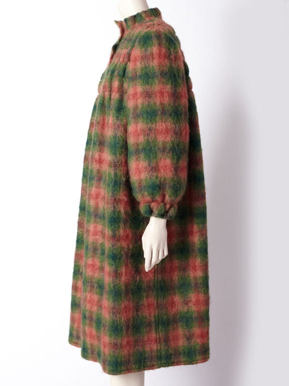 Geoffrey Beene  green and rose tone plaid mohair coat with smocking detail above the bust line and back of coat.Side pockets, full sleeve with elasticized cuff and mandarin collar are additional details.
