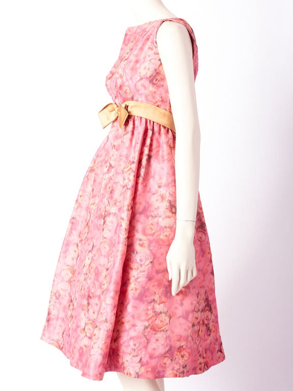 Miss Bergdorf floral print, empire waist, sleeveless, party dress made of an organza type fabric creating a sculpted silhouette. Dress has a built in corset.