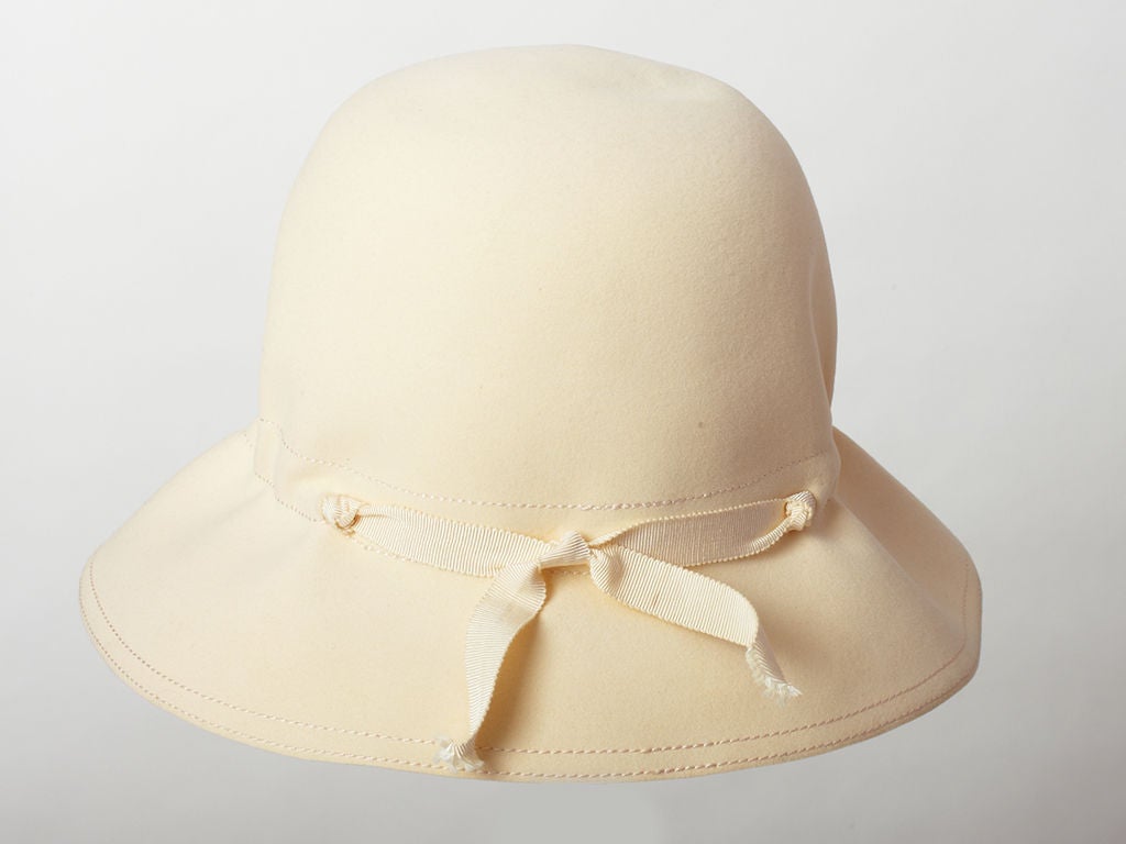 Cream felt wide brimmed cloche had with ruched and gross grain bow, detail at the crown. Label reads 