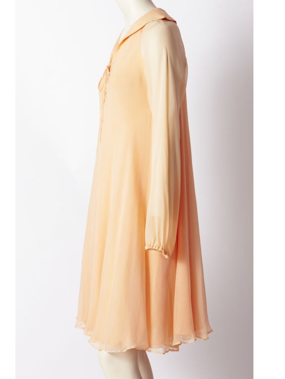 Halston multilayered, peach tone, chiffon, sheer sleeved, swing style dress with lace front detail. C. 1970'S