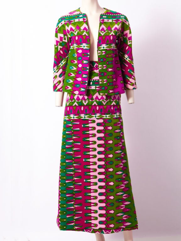 Pucci 2 piece velvet ensemble, consisting of a simple shaped, collarless jacket that ends just above the hip and a long A line shaped skirt. Geometric pattern is in shades pf magenta, pink and emerald green.