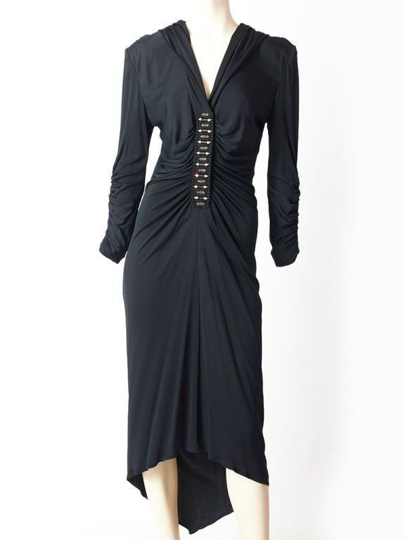 Zandra Rhodes, matte jersey, asymmetric hemline dress with ruched<br />
 bodice and sleeves. Dress has an attached hood with rhinestone<br />
embellished front middle panel and rhinestone buttons at the sleeve,