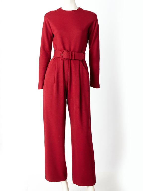 Geoffrey Beene brick red, wool jersey, long sleeve, jumpsuit, with jewel neckline, hip pockets and self belt.