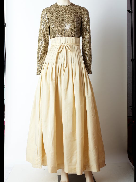 1960's sequined and taffeta empire waist gown, with a brown and beige sequined bodice giving the appearance of a textured pattern and a beige taffeta skirt that is fitted at the waist and down through the hip.There is a tubular tie at the waistline