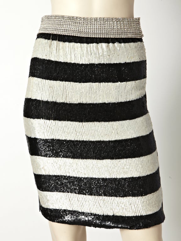 Dolce and Gabbana horizontal stripe, black and white sequined skirt with a waistband embellished with Swarovski crystal.
Back of skirt has horizontal panels of lace with jet fringe.