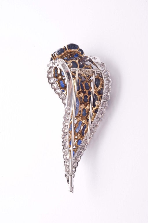18k gold and platinum carved sapphires and diamonds brooch by D.Webb, 1970.