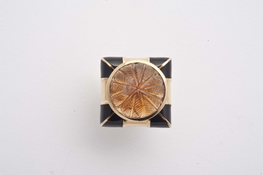 18k gold and black enamel ring set with cabouchon engraved amber by David Webb