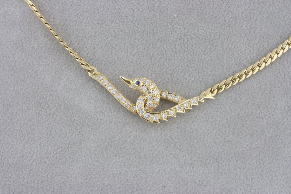14k yellow gold chain necklace featuring a unique, elegant goose design interlocking the chain. Goose features are composed of approximately 1 carat of clean white diamonds, with a sparkling sapphire eye. Signed VCA.

Van Cleef & Arpels has been a