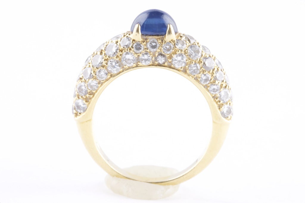 Cartier Paris. The classic Cartier ring in 18k gold. A sapphire of excellent color and clean, white diamonds. The stones are set with the precision and attention to detail that Cartier is known for. A gift that can be friendly or