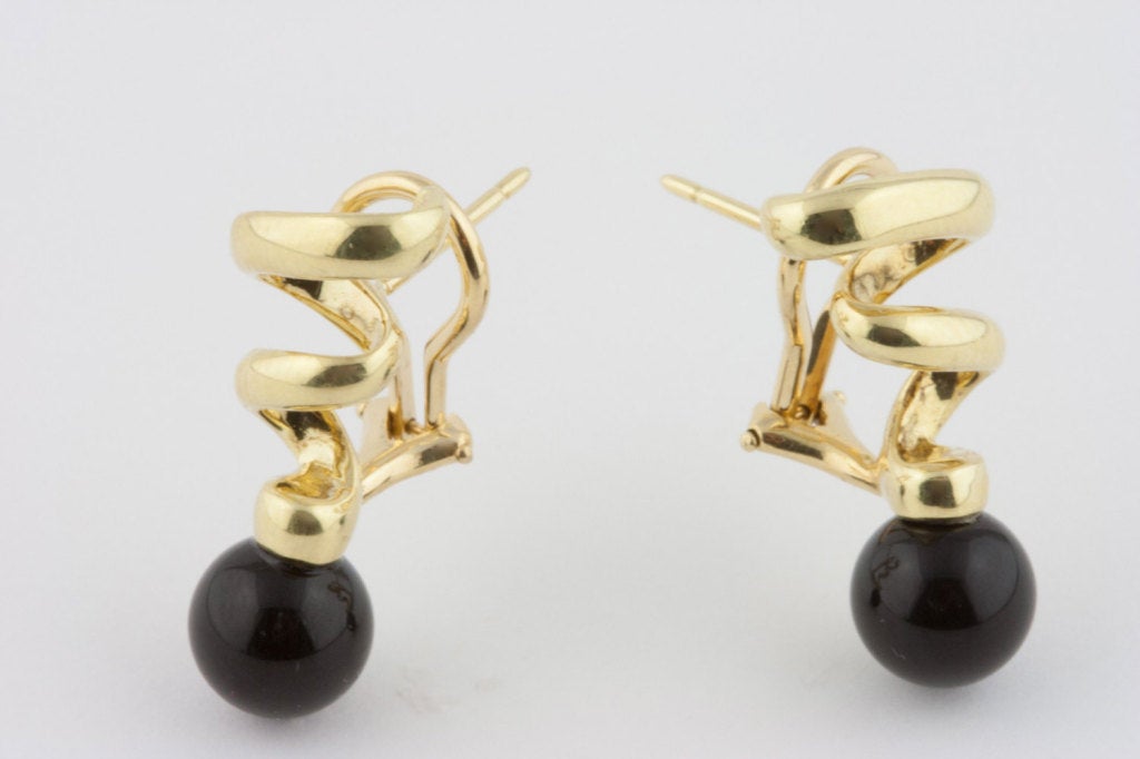 These 18k gold earrings feature a curl design, spiraling into raven black onyx spheres for a simple yet bold look. Made by Tiffany & Co.
The company's renown as an authority of taste and style, as well as the always high-end quality of its jewelry