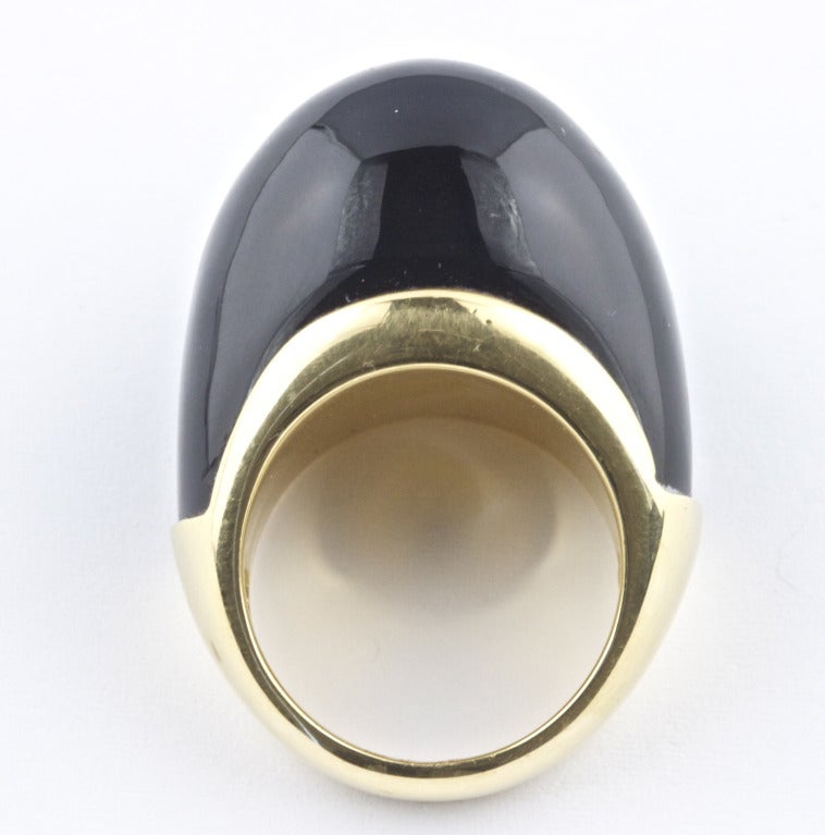Andrew Clunn worked closely with David Webb designing and creating jewelry beginning in the 1960's. In 1978 he began working on his own. This bold ring displaying a dome shaped raven black onyx gemstone echoes his early work with Webb. In 18k gold.