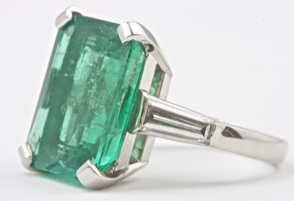 The emerald weighs 12.63 carats and GIA certifies that it is of Colombian origin. Very good rich color and a very well proportioned stone. Set in a hand made platinum ring.

Ring size 7 1/2 and can be re-sized.