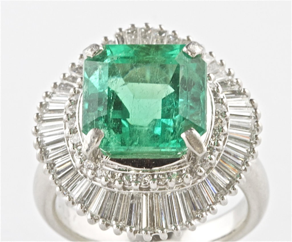 This bright green emerald has been certified by GIA as Colombian with a weight of 6.11 carats. In an extremely well made ballerina ring made of platinum.

Size 6 1/2 and can be re-sized.