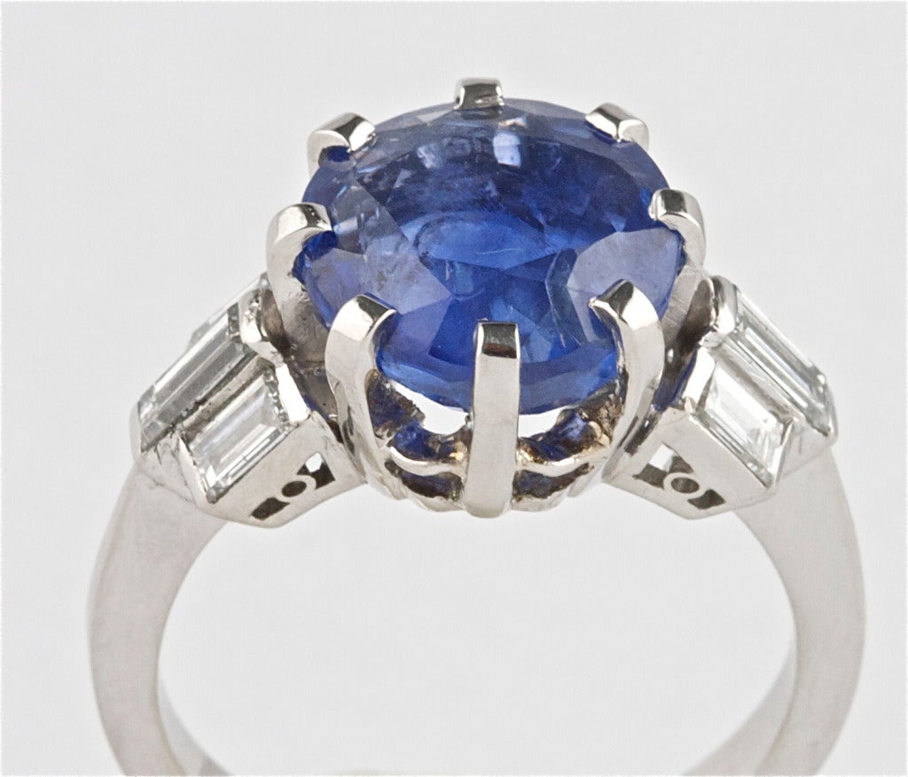 The sapphire weighs 4.97 carats and has been certified by AGL as of Burma origin, with no indications of heating or enhancement. The ring is platinum, accompanied by 6 emerald-cut diamonds.

Ring size 6 and can be re-sized.
