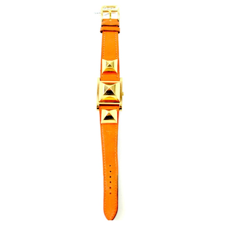 Hermes Lady's Medor Wristwatch, Gold tone on Orange strap, Quartz movement.