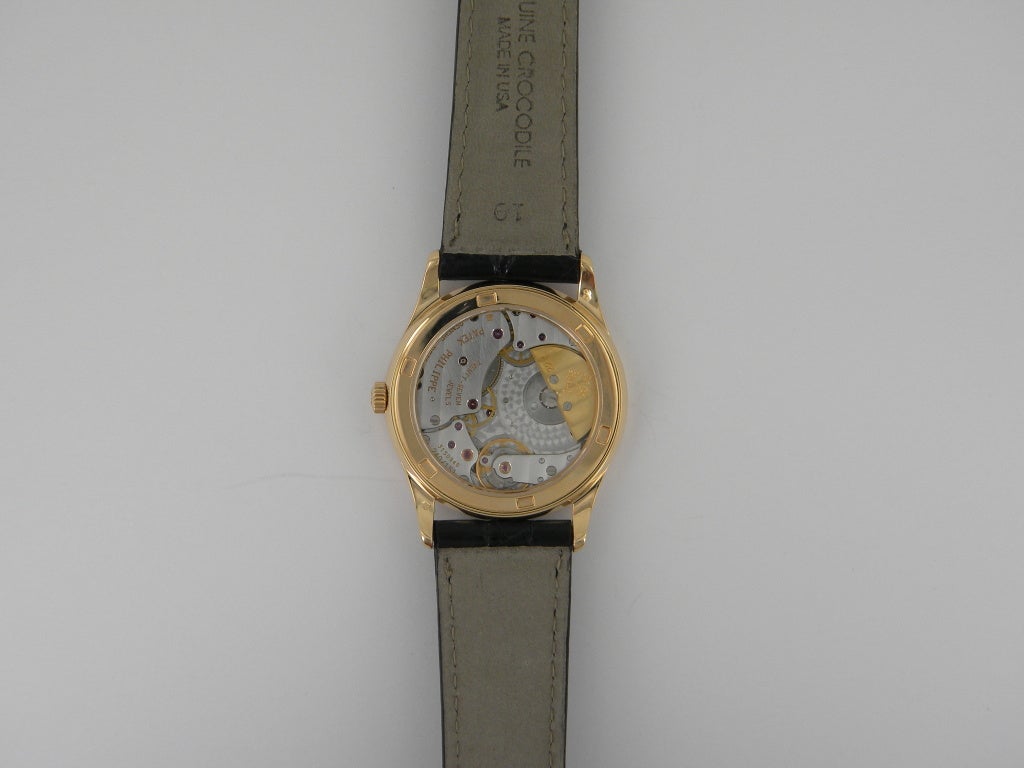 Patek Philippe 18k yellow gold Calatrava wristwatch, automatic movement, 33mm. Ref. 5026 with 18k yellow gold case and fixed bezel, display back, black dial, sapphire crystal, 18k Patek tang buckle. One year full warranty.