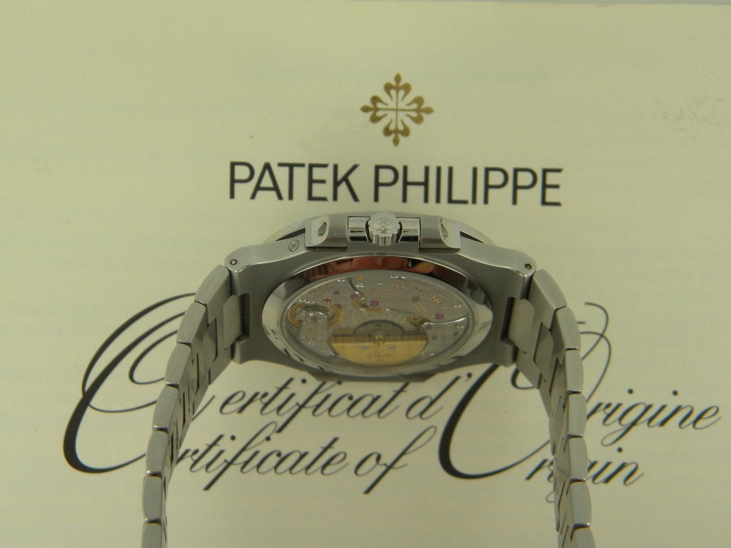 Patek Philippe stainless steel Nautilus wristwatch, Ref. 3712, automatic movement, size 38mm. Sapphire crystal display back, black dial, moon phase, subsidiary seconds, power reserve, date.

Patek box and papers. One year full warranty.