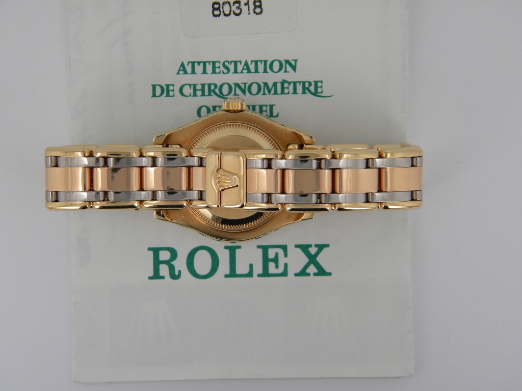 Rolex lady's 18k white, yellow and rose gold Tridor Masterpiece, automatic movement, 29mm. Ref. 80318 with 18k yellow gold case, white gold bezel with 12 diamonds, Tridor Masterpiece bracelet, Mother-of-pearl Roman dial, magnified date display,