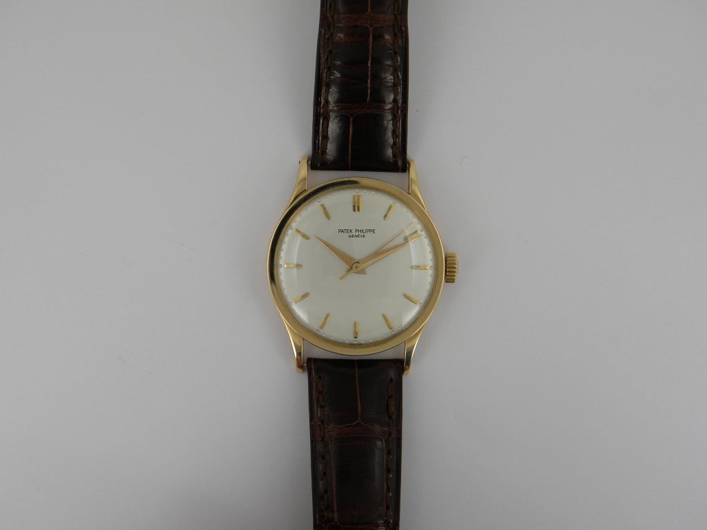 Patek Philippe 18k yellow gold Calatrava wristwatch with sweep center seconds, manual-wind movement, 35mm. Ref. 570 with 18k yellow gold case, silvered dial with baton indexes, genuine brown Patek strap. Six months full warranty.