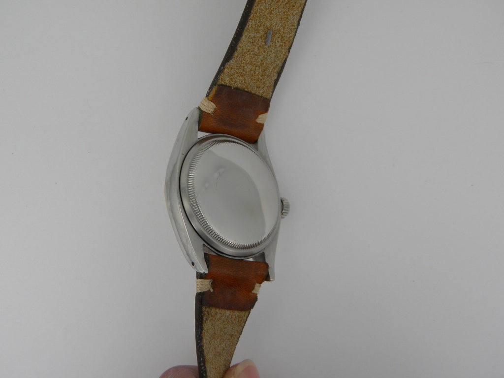 Rolex stainless steel and 14k yellow gold Datejust wristwatch, circa 1955, automatic movement, size 36mm. Rolex Ref. 6305 with a stainless steel case, 14k yellow gold bezel, ivory-colored dial, date display, acrylic crystal. Six months full warranty.