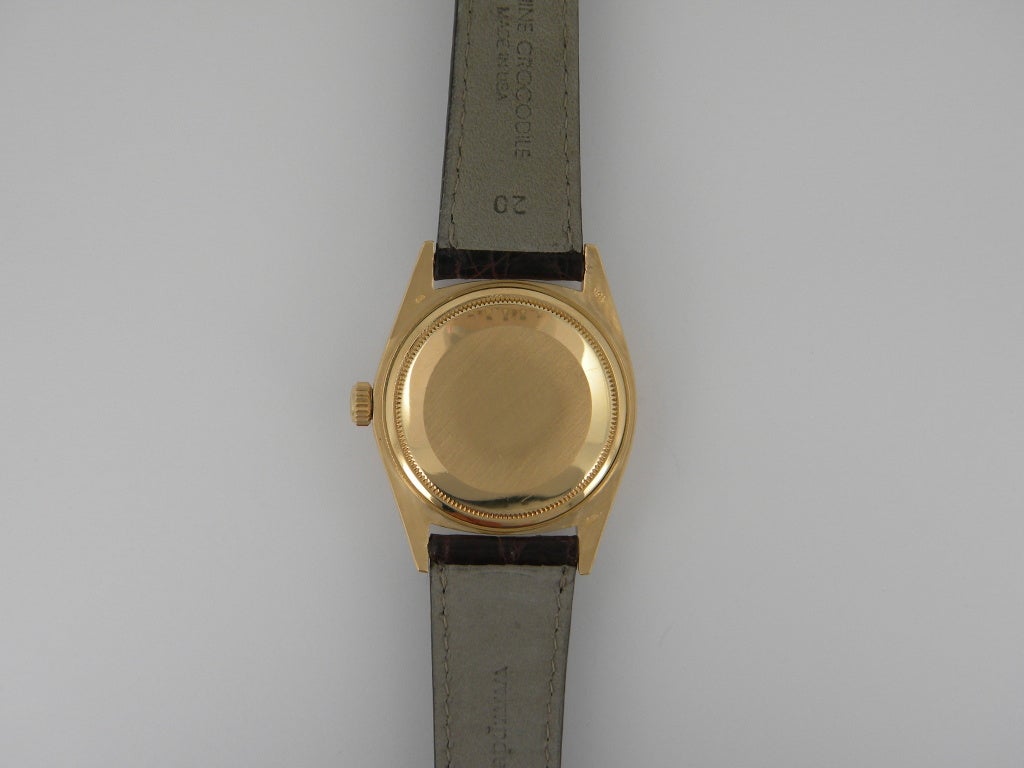 Rolex 18k yellow gold vintage Day-Date President wristwatch, automatic movement, 36mm. Ref. 1803 with 18k yellow gold case and fluted bezel, burgundy Stella dial, custom strap and buckle. Circa 1974. Complete with box, booklets and papers