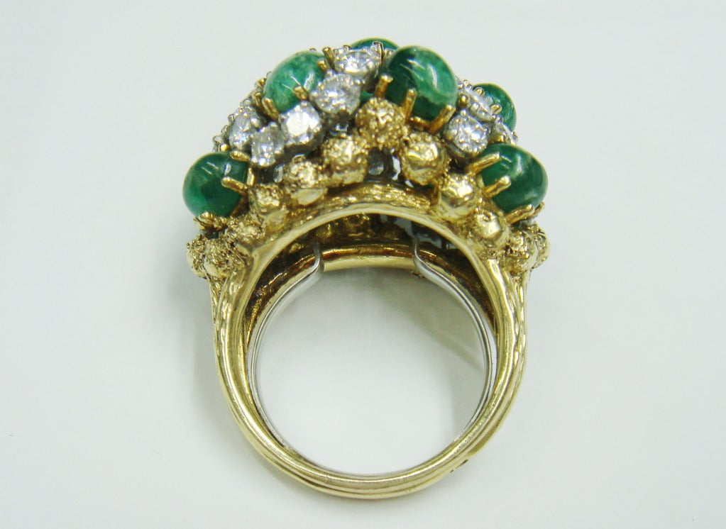 Topped by 11 oval cabochon emeralds, set with 36 round diamonds approximately 4.15 cts., accented by nugget gold balls, with maker's mark and French assay mark. 
Total weight of diamonds - 4.15ct and they are H-I-VS.
Cabochon emeralds: medium to