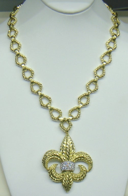 Authentic David Webb 18K Gold Chain Necklace With Detachable Fleur-de-Lys Diamond Pendant Brooch. 
The pendant-brooch designed as a textured fleur-de-lys, gathered in the center by numerous round diamonds weighing approximately 1.50 carats, gross