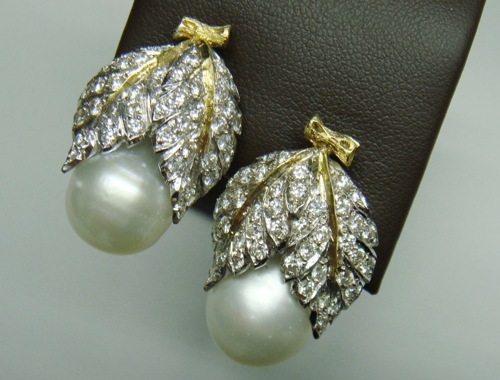 MARIO BUCCELLATI Pearl Diamond Leaf Gold Earrings. Each set with a cultured pearl, measuring approximately 12.40mm, from pierced openwork pave-set diamond leaf surmount, mounted in 18K yellow gold and platinum. 1.80 carat diamonds. Signed 