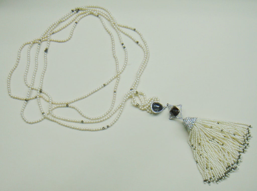 long necklace of seed pearls ending in a tassel
