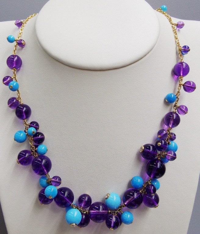 The necklace composed of a delicate oval link chain supporting clusters of amethyst beads approximately 10.2 to 4.4 mm., and turquoise beads approximately 8.0 to 4.4 mm., the earclips composed of fine gold link chains suspending clusters of amethyst