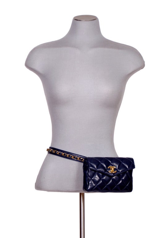 Chanel navy quilted leather hip bag with envelop front flap, classic mademoiselle CC closure, and chain detail along waist belt. belt size 80/32

Measurement(s): 7