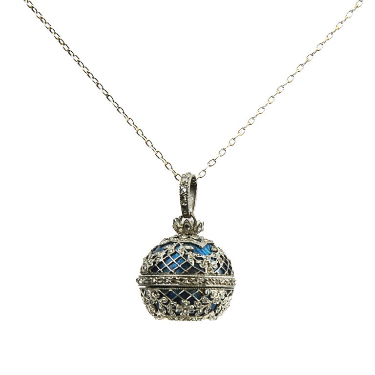 Swiss platinum and blue enamel ball watch with diamonds on a white gold chain.